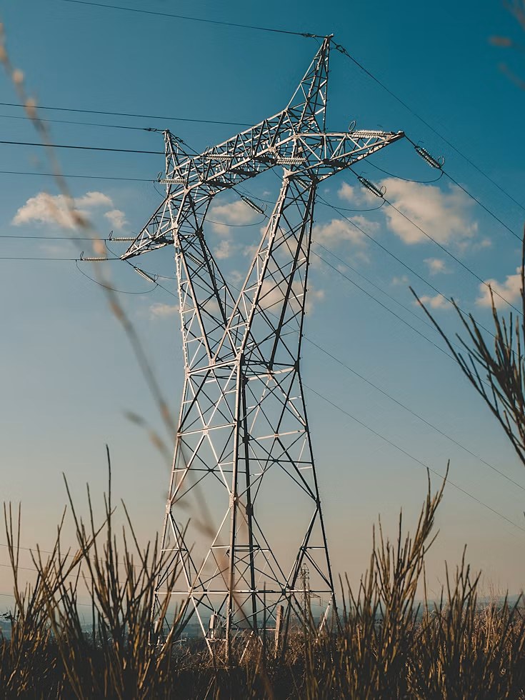 Transmission tower rising against an open sky
